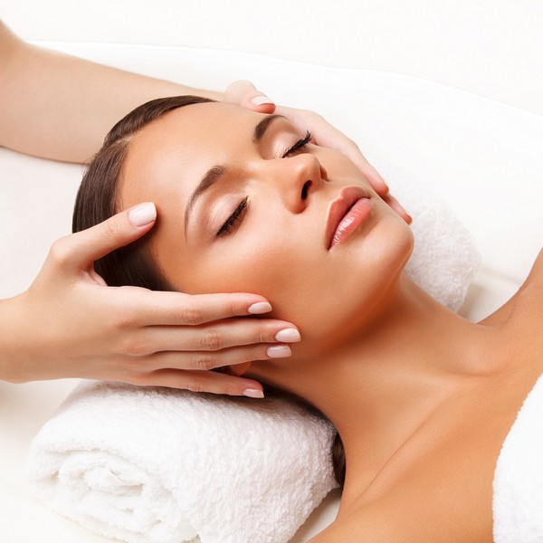 Face Massage.  Close-up of a Young Woman Getting Spa Treatment.